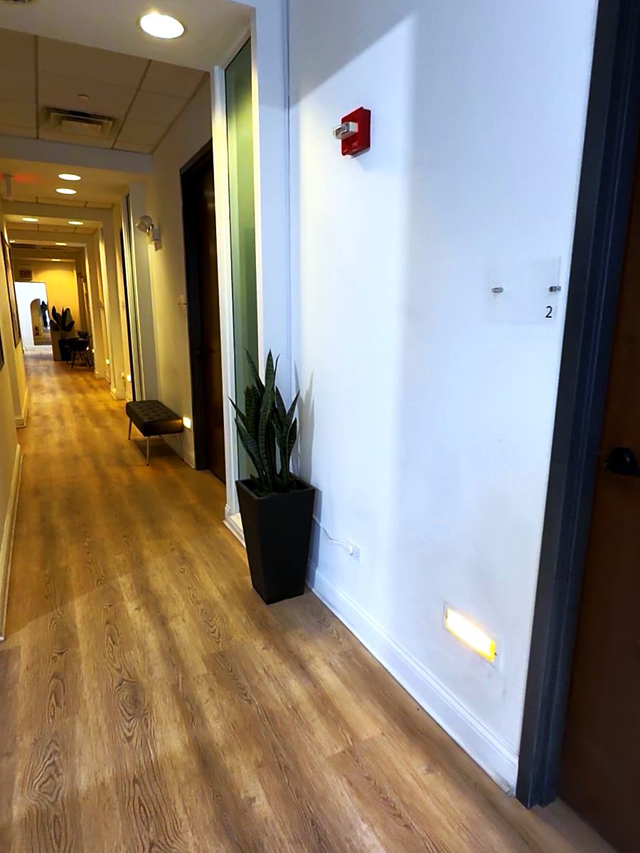 The hallway at Prestige Salon Suites, lined with numbered private suite doors