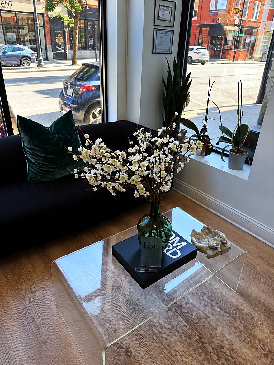 The front lounge at Prestige Salon Suites, looking out the storefront window onto North Halsted Street